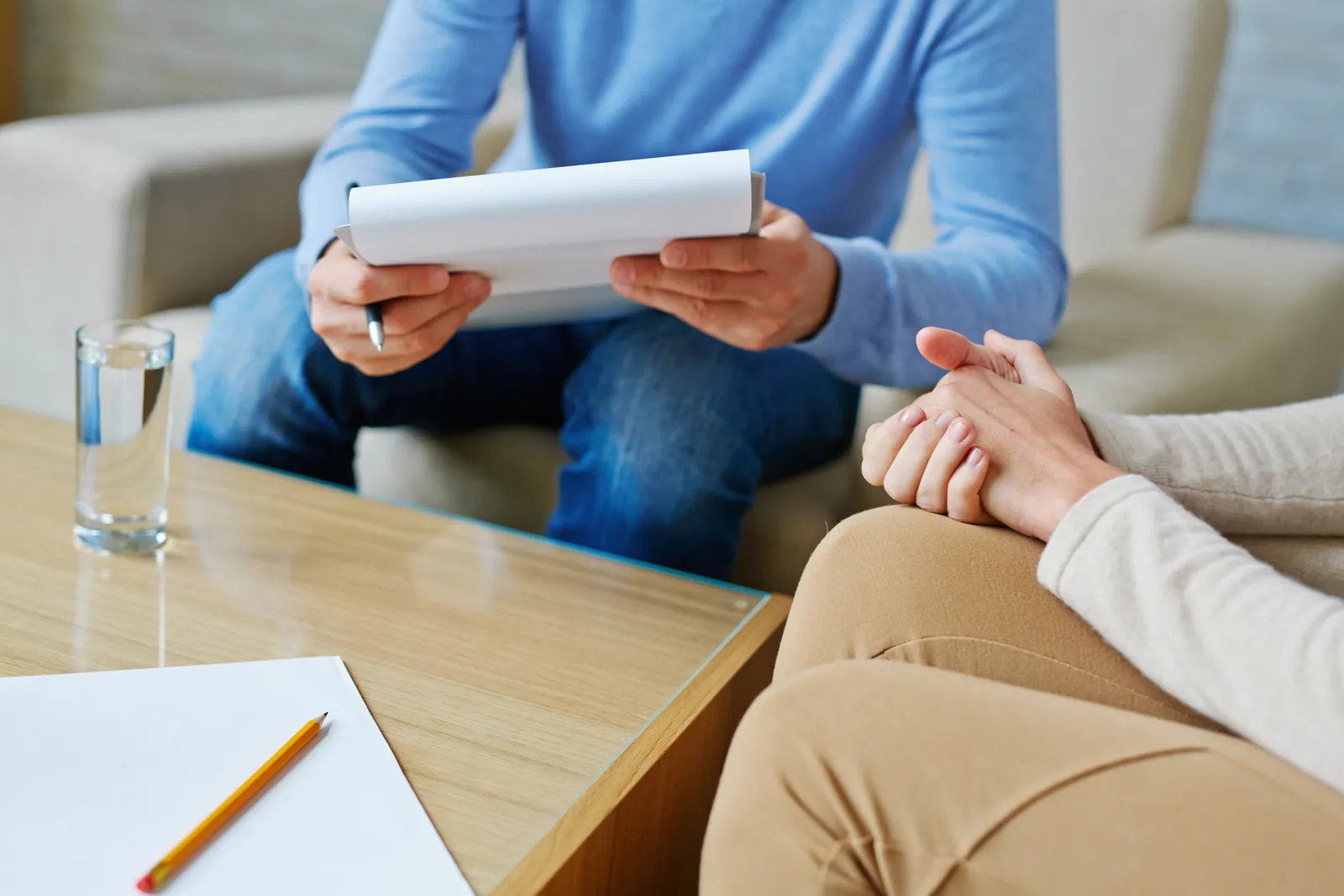 Two people seated, reviewing paperwork